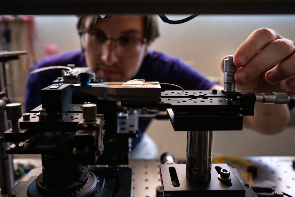 Man aligning optics
