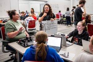 <strong>Educators Katrina Bryant and Irish Quidet work with students Brooklyn Bird, back, and Fiona Berger, during QCaMP 2025, hosted by Sandia National Labs.</strong> (Photo by Craig Fritz) Click on the thumbnail for a high-resolution image.