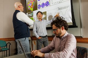 <strong>David Montes de Oca Zapiain, left, Hojun Lim, center, and Benjamin Greene chart the results and capabilities of machine-learning algorithm MAD³, which was created to accelerate materials simulation. </strong>(Photo by Bret Latter) Click on the thumbnail for a high-resolution image.