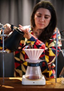 <strong>Kate Sweeney pours coffee at the Michael Thomas Coffee shop in Albuquerque. Michael Thomas Coffee collaborated with Sandia to outfit its existing roaster with a device, to use stored solar energy to roast coffee beans.</strong> (Photo by Craig Fritz) Click on the thumbnail for a high-resolution image.