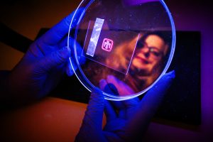 <strong>Sandia National Laboratories' material scientist Dorina Sava Gallis holds an optical tag containing printable security ink designed to detect counterfeit goods</strong>. (Photo by Craig Fritz) Click on the thumbnail for a high-resolution image or <a href=