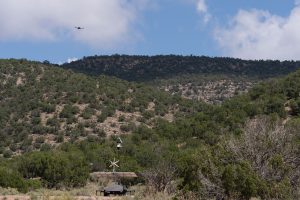 <strong>A drone flies over the Manzano Mountains during an exercise led by Sandia National Laboratories. One of the objectives was to determine if a portable system, equipped with radar and high-definition cameras that can be quickly deployed to remote areas, could pick up the drone.</strong> (Photo by David Lienemann) Click on the thumbnail for a high-resolution image.