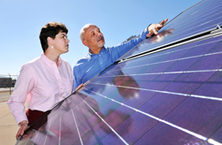 Jennifer Granata and Michael Quintana examine a photovoltaic solar panel at Sandia National Laboratories. 