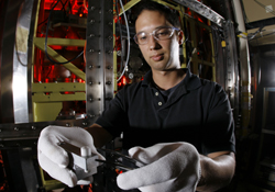 Sandia researcher Aaron Highley prepares a complex metal hydride sample for reaction kinetics analysis in the Simultaneous Thermogravimetric Modulated Beam Mass Spectrometer (STMBMS). This instrument, which was developed in the 1980s to assess the reaction kinetics that underlie the safety and aging behavior of high explosives and rocket propellants, is now being utilized to investigate the safety properties of automotive hydrogen storage materials.