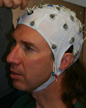 Sandia researcher Chris Forsythe is fitted with a cap connected to electroencephalogram (EEG) (brainwave) electrodes to gauge electrical activity of the brain. 