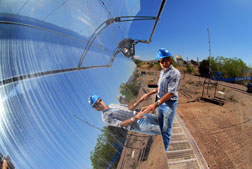 SANDIA RESEARCHER Rich Diver takes a close-up look at a parabolic trough module at the National Solar Thermal Test Facility in Albuquerque where the latest unit resides.