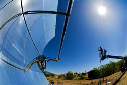 Sandia researcher Rich Diver sets up a device he has developed to calibrate trough-type solar dish collectors to maximize the amount of sunlight they capture.