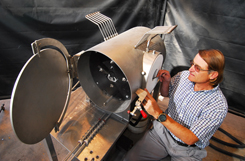 Sandia researcher Rich Diver assembles a prototype device intended to chemically reenergize carbon dioxide into carbon monoxide, which ultimately could become the building block to synthesize a liquid combustible fuel.