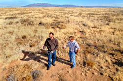 Sean McKenna and Barry Roberts check data that confirms the location of metal fragments associated with the old Kirtland bombing range.