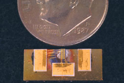 MINIATURIZED DEVICE shown next to a dime