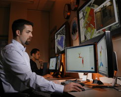 Sandia researchers Nerayo Teclemariam, Nate Gleason, and David Franco (left to right) review facility plans from a major U.S. airport. Such materials, combined with decades of research, help BIRC team members make accurate predictions for facility owners that can help secure and protect their buildings.