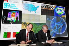 Presidents Tom Hunter, Sandia National Laboratories, and David J. Schmidly, University of New Mexico, sign an MOU between the two partners. (Photo by Randy Montoya) 